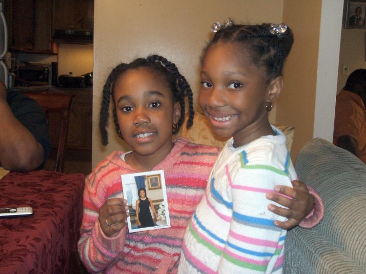 Jada Atherley, 8, of Brooklyn NY holds a photo she received from First Lady Michelle Obama. ()