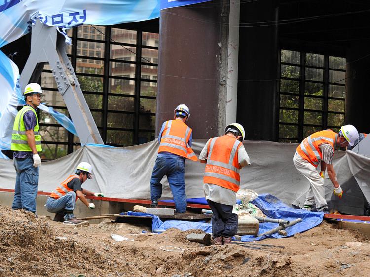 South Korean workers clean up damage done by Typhoon Kompasu. The typhoon killed dozens in North Korea. (Kim Jae-Hwan/AFP/Getty Images) South Korean workers clean up damage done by Typhoon Kompasu. The typhoon killed dozens in North Korea. (Kim Jae-Hwan/AFP/Getty Images)