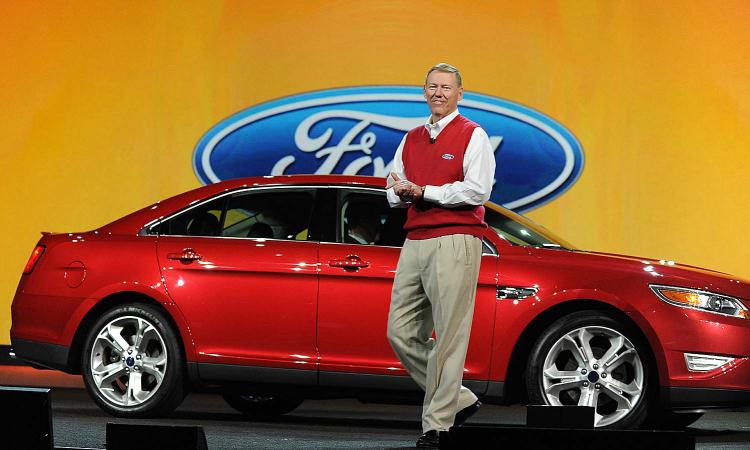Ford President and CEO Alan Mulally arrives on stage beside a new Ford Taurus to deliver the opening keynote address at the 2010 International Consumer Electronics Show, January 7, 2010 in Las Vegas, Nevada. (Robyn Beck/AFP/Getty Images)