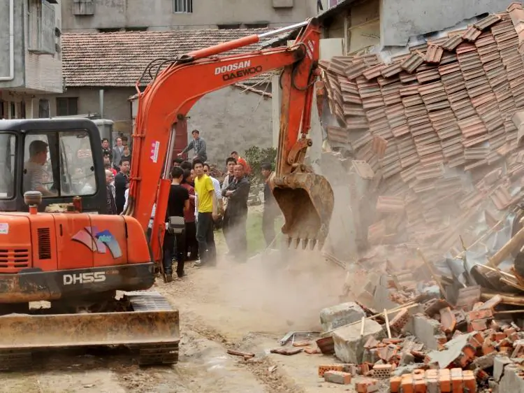 Chinese authorities demolish houses, which are claimed to be illegal by the local government in Wuhan, central China's Hubei Province, on May 7, 2010. (STR/AFP/Getty Images))