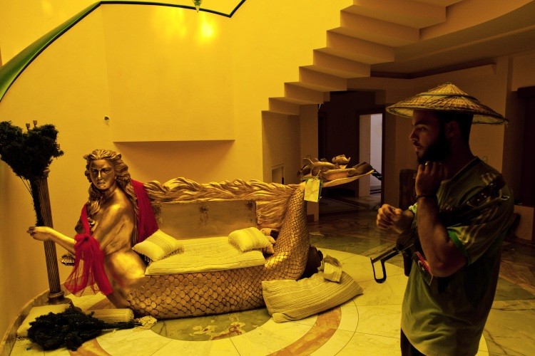 A Libyan rebel soldier walks through the house of Aisha Gadhafi. (Daniel Berehulak/Getty Images)