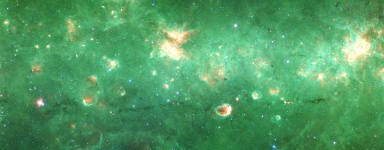 Researchers have identified the first "bone" of the Milky Way: a long tendril of dust and gas that appears dark in this infrared image from the Spitzer Space Telescope. Running horizontally along this image, the "bone" is more than 300 light-years long but only 1 or 2 light-years wide. (NASA/JPL/SSC) 