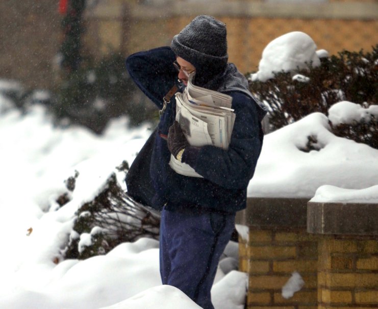 A mailman carries his deliveries