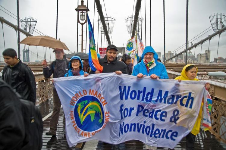 Peace activists march across the Brooklyn Bridge on Monday despite the rainy weather. (Aloysio Santos/The Epoch Times) Peace activists march across the Brooklyn Bridge on Monday despite the rainy weather. (Aloysio Santos/The Epoch Times)