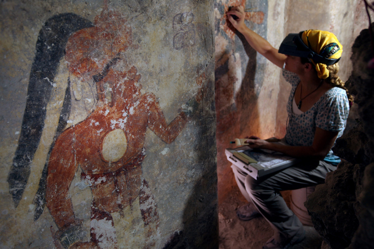 Conservator Angelyn Bass cleans and stabilizes the surface of a wall of a Maya house that dates to the 9th century A.D. The figure of a man who may have been the town scribe appears on the wall to her left. The research is supported by the National Geographic Society. (Tyrone Turner © 2012 National Geographic) Conservator Angelyn Bass cleans and stabilizes the surface of a wall of a Maya house that dates to the 9th century A.D. The figure of a man who may have been the town scribe appears on the wall to her left. The research is supported by the National Geographic Society. (Tyrone Turner © 2012 National Geographic)