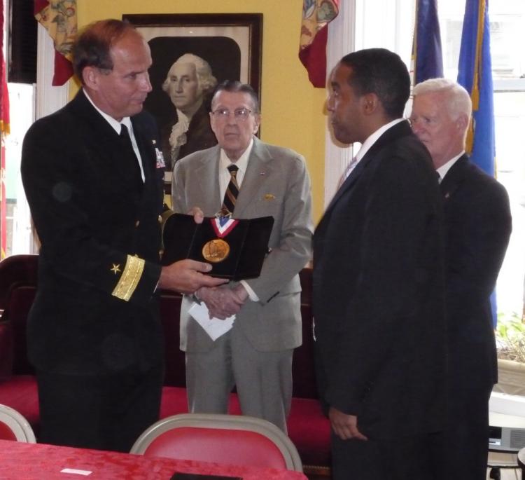 HONORED: Scott Wright of the Marine Corps receives a medal from Navy Rear Admiral Mark Kenny to welcome him into the Soldiers', Sailors' Marines', Coast Guard and Airmen's Club's Board of Honor. (Christine Lin/The Epoch Times) HONORED: Scott Wright of the Marine Corps receives a medal from Navy Rear Admiral Mark Kenny to welcome him into the Soldiers', Sailors' Marines', Coast Guard and Airmen's Club's Board of Honor. (Christine Lin/The Epoch Times)