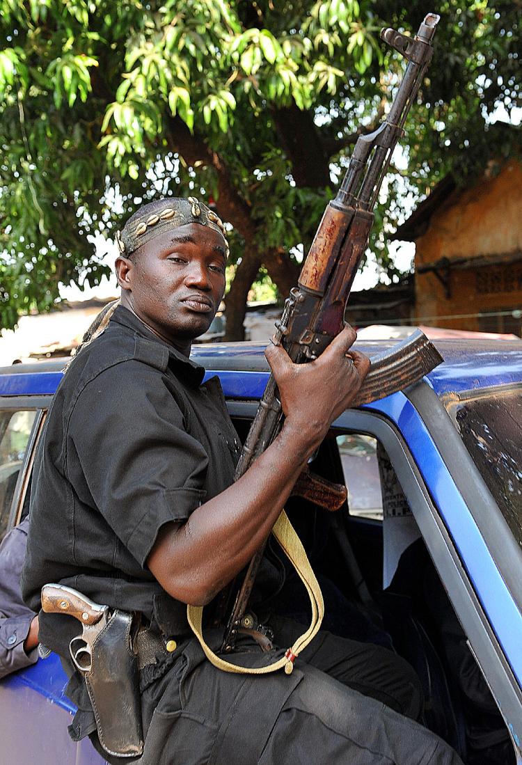 A mutinous soldier brandishes his weapon as he rides through the streets of Guinea's capital Conakry on December 24, 2008 in Conakry, following a coup. (Seyllou/AFP/Getty Images)
