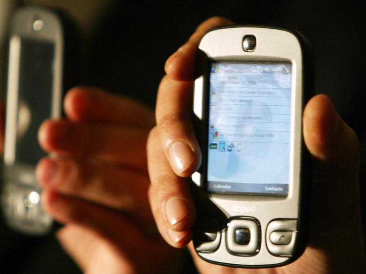 An Indian model displays a Dopod International windows compatable mobile phone/ PDA during a launch function in Mumbai, 05 Feburary 2007. (Sajjad Hussain/AFP/Getty Images) An Indian model displays a Dopod International windows compatable mobile phone/ PDA during a launch function in Mumbai, 05 Feburary 2007. (Sajjad Hussain/AFP/Getty Images)