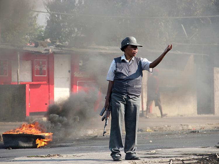 A Mozambiquea police woman gestures on a street of Maputo on September 2, 2010. Fresh clashes between police and demonstrators broke out as violent protests over food and fuel prices moved into a second day. (Arthur Frayer/AFP/Getty Images) A Mozambiquea police woman gestures on a street of Maputo on September 2, 2010. Fresh clashes between police and demonstrators broke out as violent protests over food and fuel prices moved into a second day. (Arthur Frayer/AFP/Getty Images)