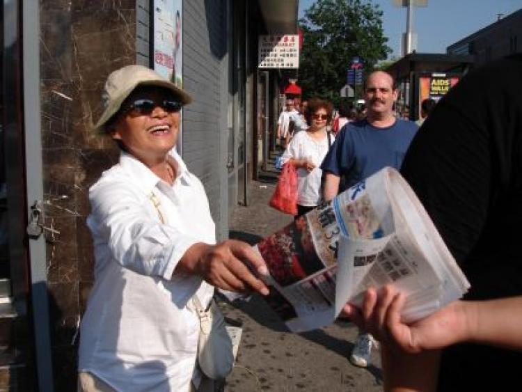 Seventy-year-old Ms. Dai Keyue is a volunteer newspaper deliverer in Flushing. (The Epoch Times)