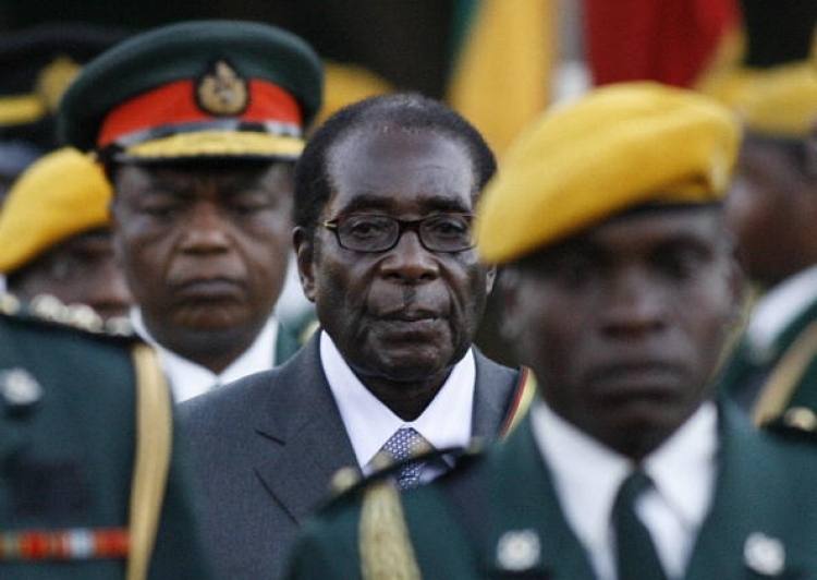 Zimbabwean President Robert Mugabe walks with a guard to be sworn in for a sixth term in office in Harare, on June 29, 2008 after being declared the winner of a one-man election. (Alexander Joe/AFP/Getty Images)