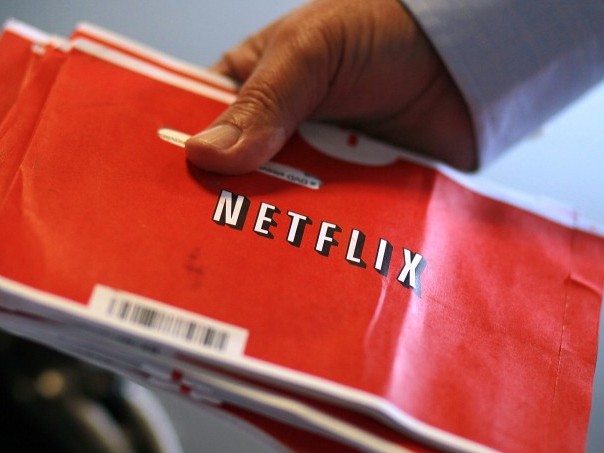 Netflix Reports Third Quarter Earnings A U.S. Postal worker holds a stack of Netflix envelopes