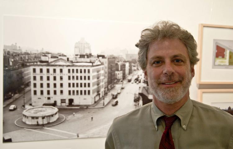 BEFORE THEY WERE PARKS: Curator Jonathan Kuhn stands next to a photo of the Stetler Warehouse, now the site of the Bleeker Street Playground. (June Kellum/Epoch Times Staff ) BEFORE THEY WERE PARKS: Curator Jonathan Kuhn stands next to a photo of the Stetler Warehouse, now the site of the Bleeker Street Playground. (June Kellum/Epoch Times Staff )