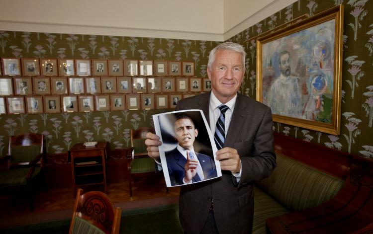 The chairman of the Norwegian Nobel Peace Prize Committee, Thorbjoern Jagland shows a picture of 2009 Nobel peace prize laureate, Barack Obama, after the announcement of the winner in Oslo 9 October 2009.  (Daniel Sannum Lauten/AFP/Getty Images)