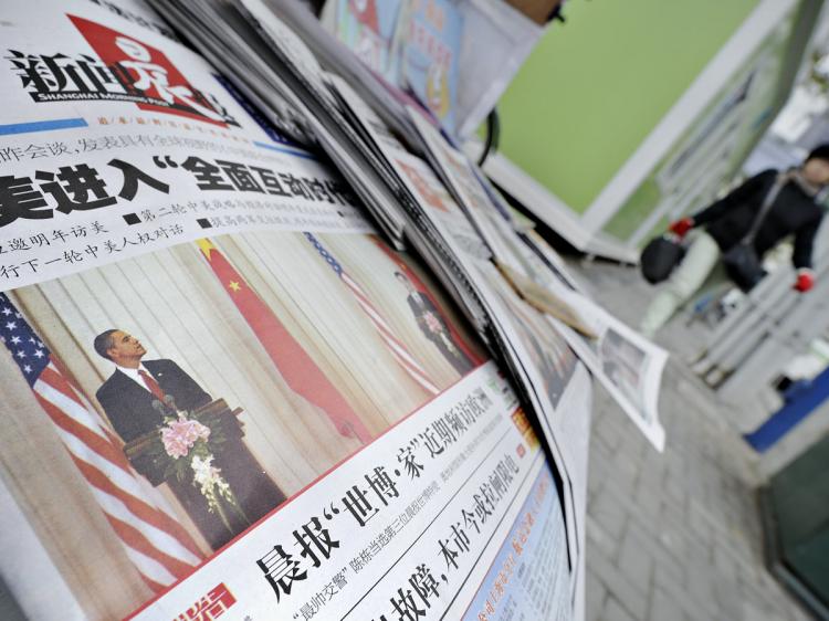 A woman (R) walks past a news stand in Shanghai where Chinese newspapers reporting US President Barack Obama's visit to China are displayed on November 18, 2009. (Philippe Lopez/AFP/Getty Images) A woman (R) walks past a news stand in Shanghai where Chinese newspapers reporting US President Barack Obama's visit to China are displayed on November 18, 2009. (Philippe Lopez/AFP/Getty Images)