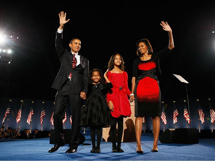 U.S. President elect Barack Obama stands on stage along with his wife Michelle and daughters Malia (red dress) and Sasha (black dress) during an election night gathering in Grant Park on November 4, 2008 in Chicago, Illinois. (Joe Raedle/Getty Images) U.S. President elect Barack Obama stands on stage along with his wife Michelle and daughters Malia (red dress) and Sasha (black dress) during an election night gathering in Grant Park on November 4, 2008 in Chicago, Illinois. (Joe Raedle/Getty Images)
