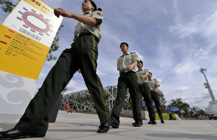Chinese security personnel patrol the Olympics ground on Aug. 1, 2008, in preparation for the Beijing Olympics. Free speech activists and other citizens detained in connection with the Beijing Olympics are still being held six months after the games. (Jewel Samad/AFP/Getty Image) Chinese security personnel patrol the Olympics ground on Aug. 1, 2008, in preparation for the Beijing Olympics. Free speech activists and other citizens detained in connection with the Beijing Olympics are still being held six months after the games. (Jewel Samad/AFP/Getty Image)