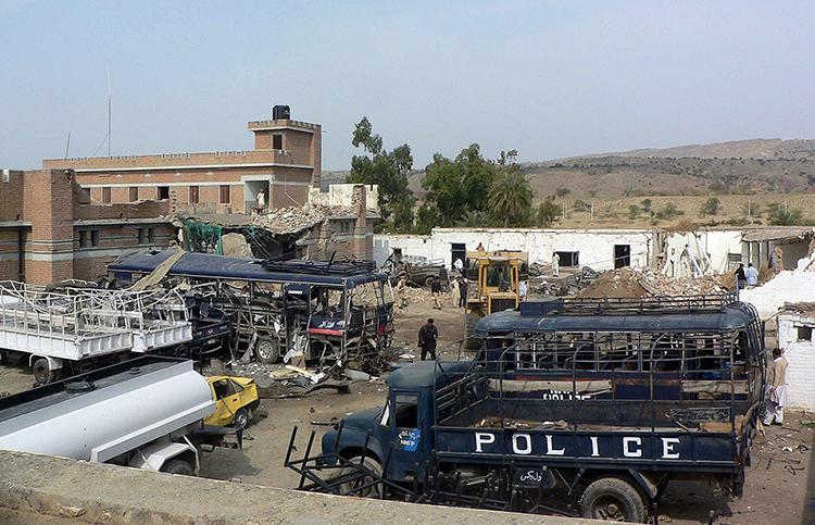 Pakistani security officials stand beside wreckage and a damaged police station building after a suicide bomb attack in Karak, southeast of Peshawar, in February 2010. (Karim Ullah/AFP/Getty Images) Pakistani security officials stand beside wreckage and a damaged police station building after a suicide bomb attack in Karak, southeast of Peshawar, in February 2010. (Karim Ullah/AFP/Getty Images)