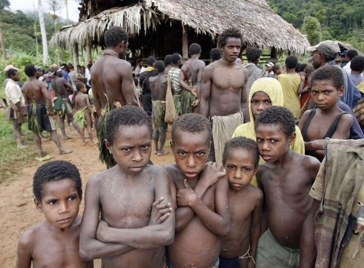 Children from the primitive Andai tribe of hunter-gatherers wait for their parents to vote at the Kaiam village polling station in the East Sepik Province during Papua New Guinea's general election, July 5, 2007. PNG is the most culturally diverse nation on earth with over 800 languages spoken by the population of nearly six millionâ��many of whom are living in extremely remote highland and island communities. (Torsten Blackwood/AFP/Getty Images)