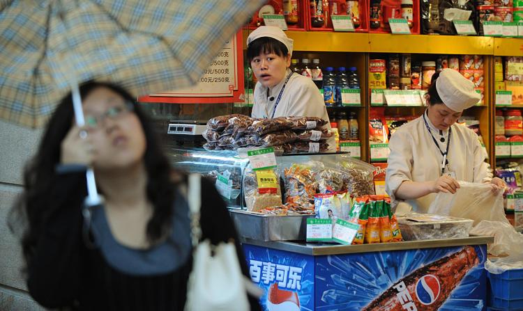 Two Chinese service staff wait for customers at their grocery shop in Shanghai. Food prices have reached a 12-year high that has spurred the government to freeze prices of key consumer items such as grain, edible oil, meat, milk and liquefied petroleum ga (Mark Ralston/AFP/Getty Images) Two Chinese service staff wait for customers at their grocery shop in Shanghai. Food prices have reached a 12-year high that has spurred the government to freeze prices of key consumer items such as grain, edible oil, meat, milk and liquefied petroleum ga (Mark Ralston/AFP/Getty Images)