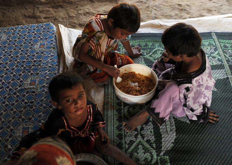 Pakistani children, displaced by floods, eat food at a makeshift camp in Karachi. (Asif Hassan/AFP/Getty Images) Pakistani children, displaced by floods, eat food at a makeshift camp in Karachi. (Asif Hassan/AFP/Getty Images)