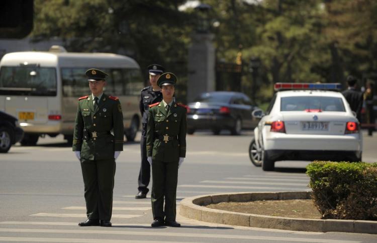 Police stand guard as a diplomatic motorcade enters the Diaoyutai State guest house in Beijing on May 6, 2010. North Korean leader, Kim Jong-Il, along with his 17-car luxury motorcade, made his fifth visit to China from May 3 to May 7. (Peter Parks/AFP/Getty Images) Police stand guard as a diplomatic motorcade enters the Diaoyutai State guest house in Beijing on May 6, 2010. North Korean leader, Kim Jong-Il, along with his 17-car luxury motorcade, made his fifth visit to China from May 3 to May 7. (Peter Parks/AFP/Getty Images)
