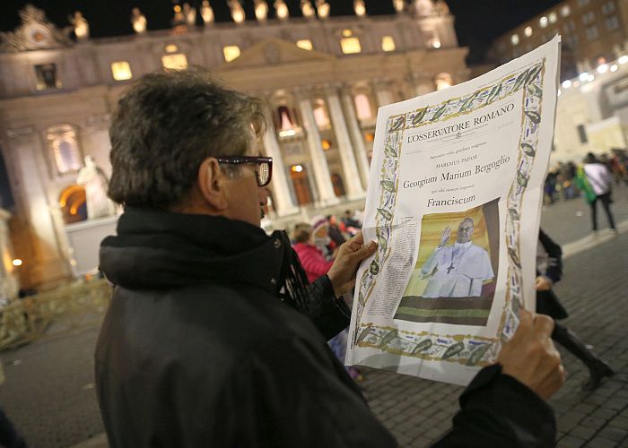  A man reads a special edition of the L'Osservatore Romano newspaper which carries a photo of newly elected Pope Francis I in Vatican City on March 13. (Peter Macdiarmid/Getty Images) 