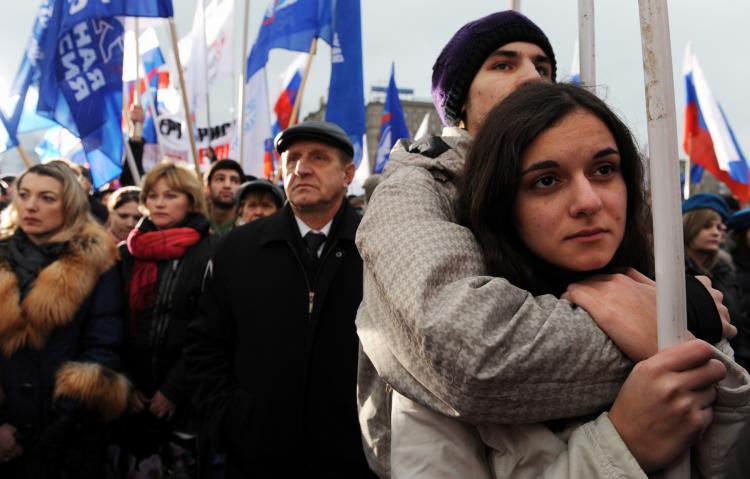 Russians attend an anti-terrorism rally organized by the dominant United Russia political party in memory of those who died in the recent Nevsky Express passenger train tragedy, in Moscow on Dec. 2.  (Alexander Nemenov/AFP/Getty Images)