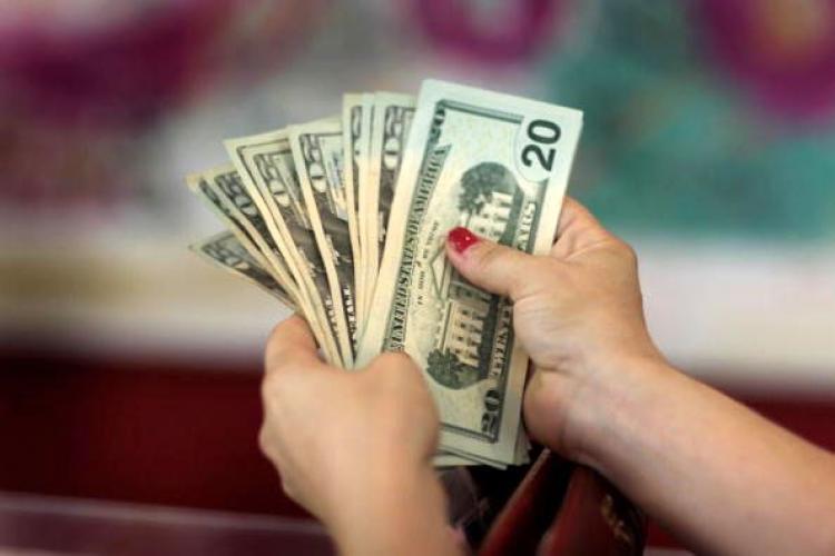 A woman holds money in an apparel store in Miami, Florida. The most recent U.S. economic recession officially ended in June 2009. (Joe Raedle/Getty Images) A woman holds money in an apparel store in Miami, Florida. The most recent U.S. economic recession officially ended in June 2009. (Joe Raedle/Getty Images)