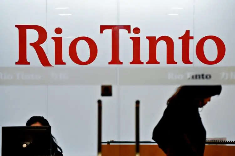 An employee of Australian mining giant Rio Tinto walks past a sign at the Shanghai offices of the firm on February 11, 2010. (Philippe Lopez/AFP/Getty Images)