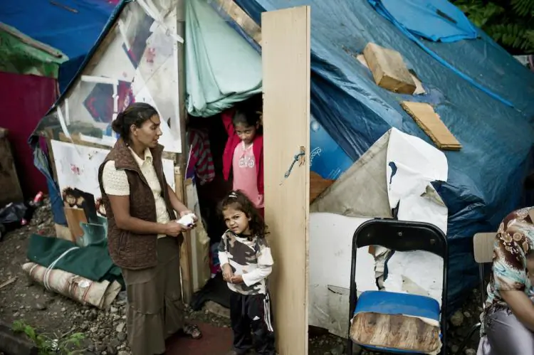 Women and children, who belong to the Roma community, stand near a shack in a camp near Lyons, France on July 29 . (Jeff Pachoud/AFP/Getty Images)