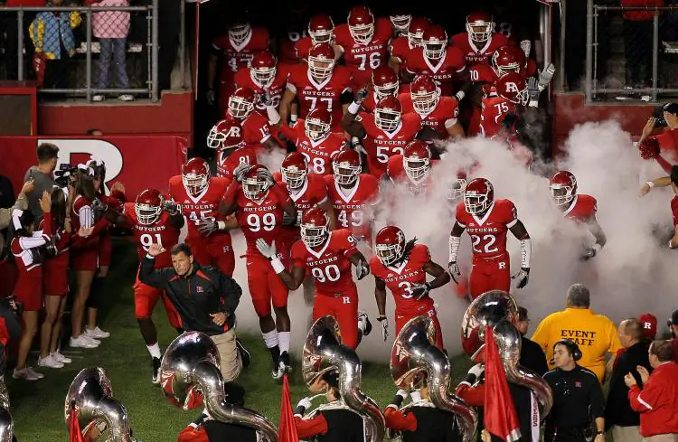Head coach Greg Schiano of the Rutgers Scarlet Knights leads his team onto the field to play against the Connecticut Huskies in a file photo. (Jim McIsaac/Getty Images)