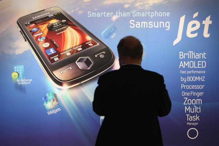 A visitor stops at a poster for Samsung's new Jet smartphone at the Samsung stand on opening day at the IFA technology trade fair on September 4, 2009 in Berlin, Germany. (Sean Gallup/Getty Images) A visitor stops at a poster for Samsung's new Jet smartphone at the Samsung stand on opening day at the IFA technology trade fair on September 4, 2009 in Berlin, Germany. (Sean Gallup/Getty Images)