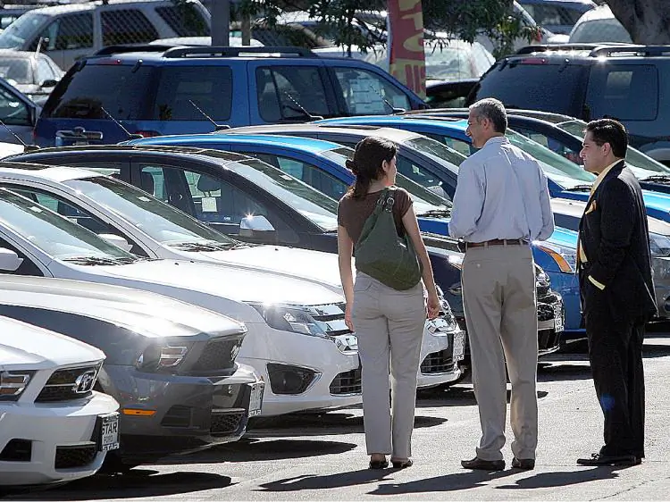 Customers shop for cars at a dealership in Glendale, Calif. (David McNew/Getty Images)