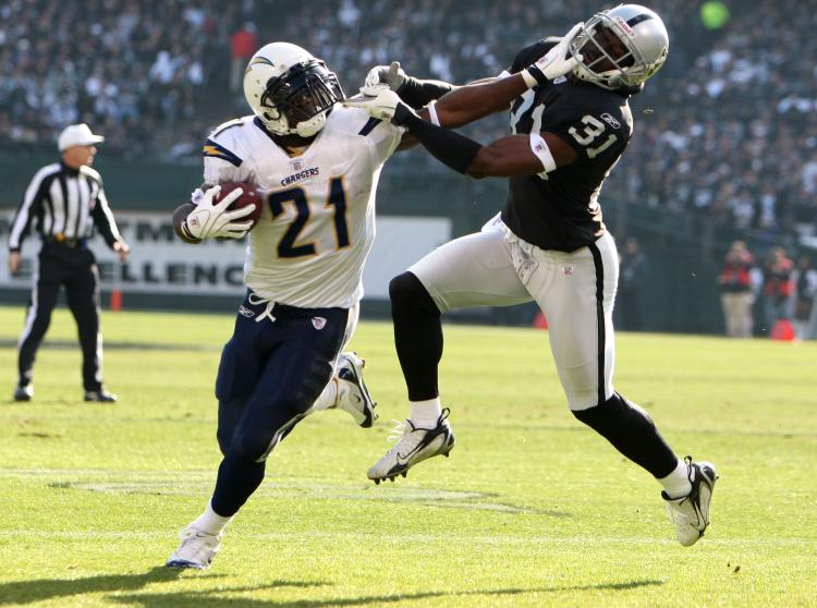 STIFF ARM: San Diego's LaDainian Tomlinson has had some memorable games against the Oakland Raiders in recent seasons. (Jed Jacobsohn/Getty Images) STIFF ARM: San Diego's LaDainian Tomlinson has had some memorable games against the Oakland Raiders in recent seasons. (Jed Jacobsohn/Getty Images)