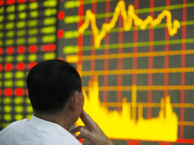 An investor watches the electronic board at a stock exchange hall in China. On June 4, the 23rd anniversary of the 1989 massacre of students, the Shanghai Stock Exchange index fell 64.89 points—a seeming reference to the date of the massacre. (ChinaFotoPress/Getty Images)