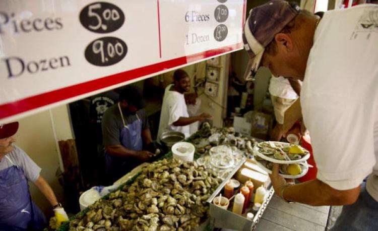 A man eats oysters on the half shell at the Washington Seafood Market. Researchers found large quantities of contaminants in shellfish and soil in the Gulf of Mexico. (Jim Watson/AFP/Getty Images) A man eats oysters on the half shell at the Washington Seafood Market. Researchers found large quantities of contaminants in shellfish and soil in the Gulf of Mexico. (Jim Watson/AFP/Getty Images)