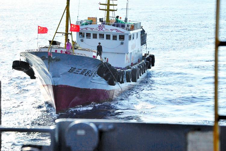 A crewmember on a Chinese trawler uses a grapple hook in an apparent attempt to snag the towed acoustic array of the military Sealift Command ocean surveillance ship USNS Impeccable (Courtesy of U.S. Navy) A crewmember on a Chinese trawler uses a grapple hook in an apparent attempt to snag the towed acoustic array of the military Sealift Command ocean surveillance ship USNS Impeccable (Courtesy of U.S. Navy)