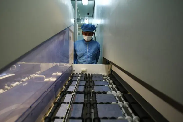 A worker controls the production line of the silicon chips which used for making photoelectric board product at the plant of Tianwei Yingli Green Energy Resources Co., Ltd on June 24, 2009 in Baoding, China. (Feng Li/Getty Images)