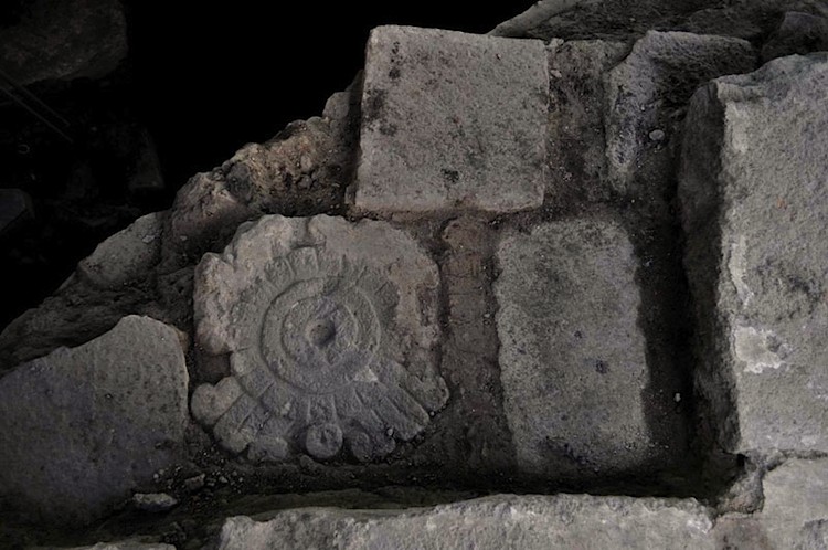 A stone tablet carved with scrolls resembling smoke. (INAH) A stone tablet carved with scrolls resembling smoke. (INAH)