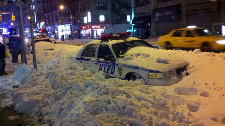 SHOVELS NEEDED: The blizzard might have passed but the snow remains, as this buried NYC police car clearly shows. (John Nania/The Epoch Times) SHOVELS NEEDED: The blizzard might have passed but the snow remains, as this buried NYC police car clearly shows. (John Nania/The Epoch Times)
