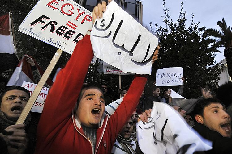 Egyptians living in Athens carry placards reading ''Mubarak go'' and ''Egyptian equal freedom'' during a protest against Egyptian president Hosni Mubarak's regime, outside the Egyptian embassy in Athens, on January 28, 2011. Demonstrations in Egypt, inspired by the 'Jasmine Revolution' in Tunisia, have swelled into the largest uprising in three decades, sending shockwaves across the region. (Louisa Gouliamaki/AFP/Getty Images) Egyptians living in Athens carry placards reading ''Mubarak go'' and ''Egyptian equal freedom'' during a protest against Egyptian president Hosni Mubarak's regime, outside the Egyptian embassy in Athens, on January 28, 2011. Demonstrations in Egypt, inspired by the 'Jasmine Revolution' in Tunisia, have swelled into the largest uprising in three decades, sending shockwaves across the region. (Louisa Gouliamaki/AFP/Getty Images)