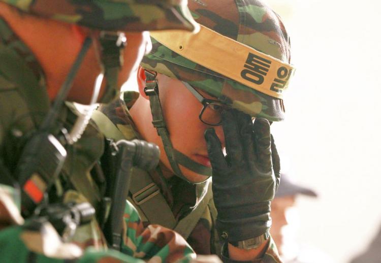 South Korean soldiers take shelter in a bunker during a live-fire exercise on Yeonpyeong island near the disputed waters of the Yellow Sea on Dec. 20. South Korea held a live-fire military drill on a border island and scrambled fighter jets despite North Korean threats of deadly retaliation, as U.N. diplomacy on the crisis broke down. (Korea Pool/AFP/Getty Images) South Korean soldiers take shelter in a bunker during a live-fire exercise on Yeonpyeong island near the disputed waters of the Yellow Sea on Dec. 20. South Korea held a live-fire military drill on a border island and scrambled fighter jets despite North Korean threats of deadly retaliation, as U.N. diplomacy on the crisis broke down. (Korea Pool/AFP/Getty Images)