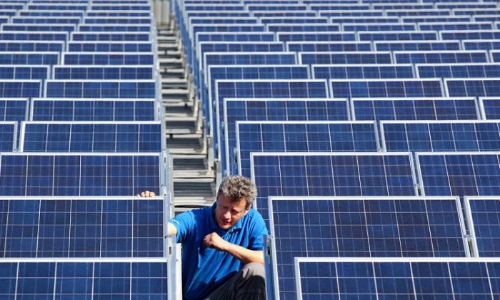 A technician checks the panels of a solar power system. Green energy technicians will be in demand as alternative energy is replaces fossil fuels. (Michael Urban/AFP/Getty Images)