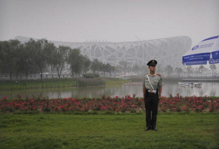 Beijing's National Stadium, the Bird's Nest, under Para-military police guard.Beijing was awarded the Olympic Games venue seven years ago. Despite the Birds Nest, no one can fly free, like a bird emerging from its nest. (Peter Parks/AFP/Getty) Beijing's National Stadium, the Bird's Nest, under Para-military police guard.Beijing was awarded the Olympic Games venue seven years ago. Despite the Birds Nest, no one can fly free, like a bird emerging from its nest. (Peter Parks/AFP/Getty)