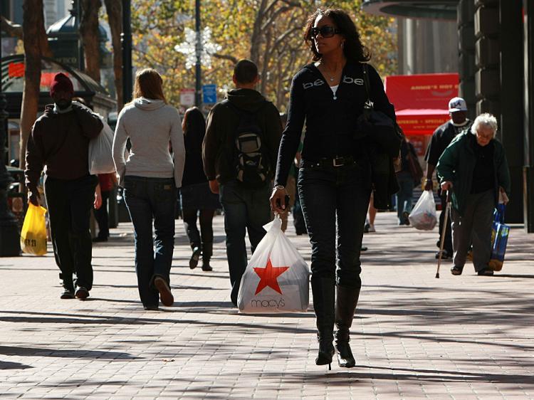 A shopper carries a bag from Macy's as she walks down Market Street in San Francisco, California. (Justin Sullivan/Getty Images) A shopper carries a bag from Macy's as she walks down Market Street in San Francisco, California. (Justin Sullivan/Getty Images)