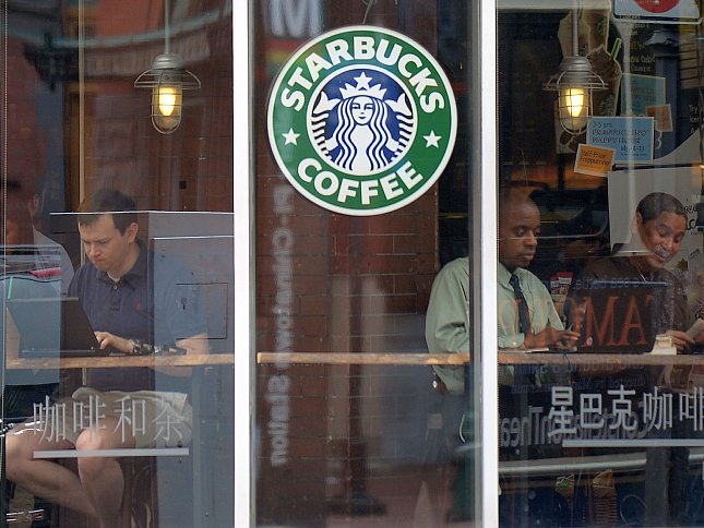 People use their laptop computers at a Starbucks in Washington, D.C. People use their laptop computers at a Starbucks in Washington, D.C.