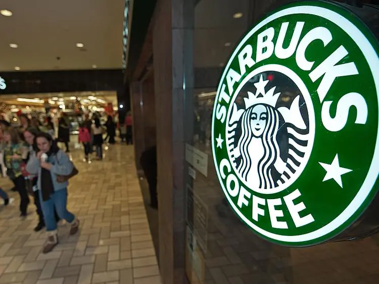 Holiday shoppers walk past a Starbucks Coffee shop at Tyson's Corner mall in McLean, Va., on Dec. 23, 2009. (Paul J. Richards/AFP/Getty Images)