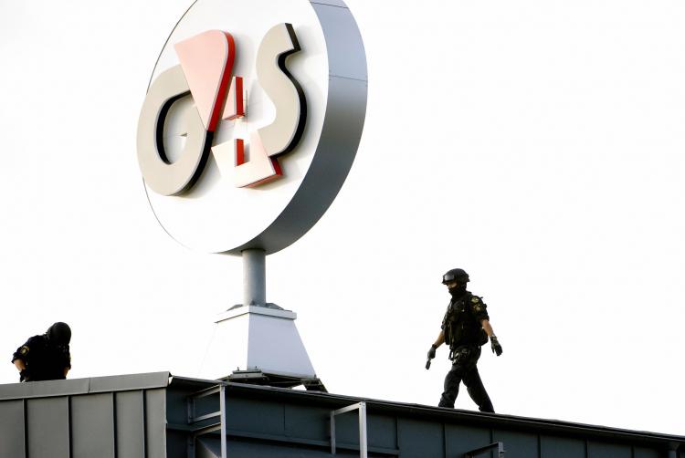 A police SWAT team inspects the roof of the G4S cash depot in Vastberga, Stockholm on Wednesday, after robbers used a helicopter to carry out a robbery at the cash depot. (Pontus Lundahl/AFP/Getty Images) A police SWAT team inspects the roof of the G4S cash depot in Vastberga, Stockholm on Wednesday, after robbers used a helicopter to carry out a robbery at the cash depot. (Pontus Lundahl/AFP/Getty Images)