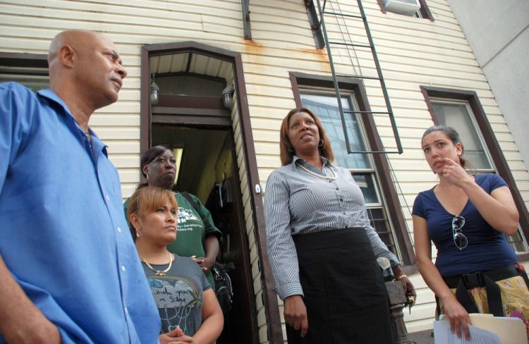 Council member Letitia James (2R) stands with tenants and Pratt Area Community Council members in front of 71 Grand Ave. in Brooklyn.  (Helena Zhu/The Epoch Times)